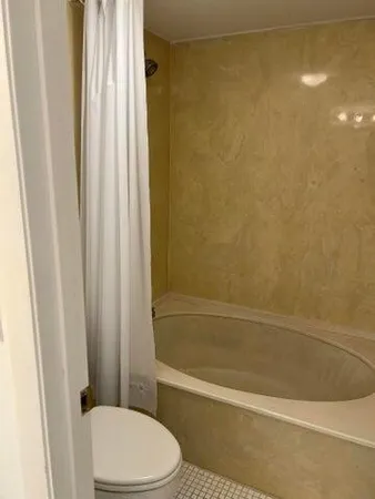 a bathroom with a toilet and shower