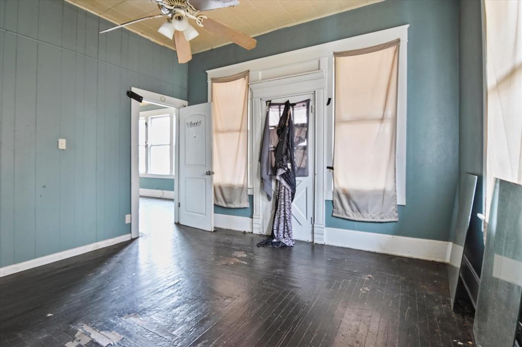 738 1st Street Southwest Paris, TX 75460 - Photo 11 of 25 a view of an empty room with wooden floor and a window