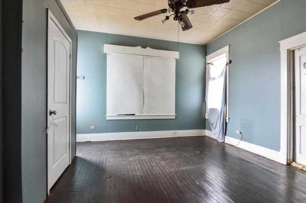 738 1st Street Southwest Paris, TX 75460 - Photo 12 of 25 a view of an empty room with wooden floor and a window