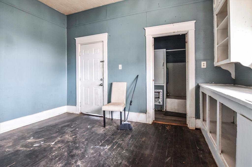 738 1st Street Southwest Paris, TX 75460 - Photo 8 of 25 a view of an empty room with wooden floor and a window