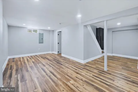 a view of an empty room with wooden floor