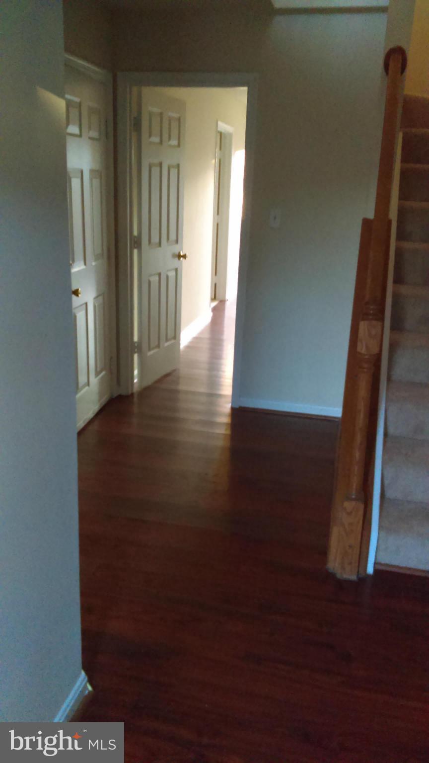 11117 Light Guard Loop Manassas, VA 20109 - Photo 2 of 25 a view of a hallway with wooden floor