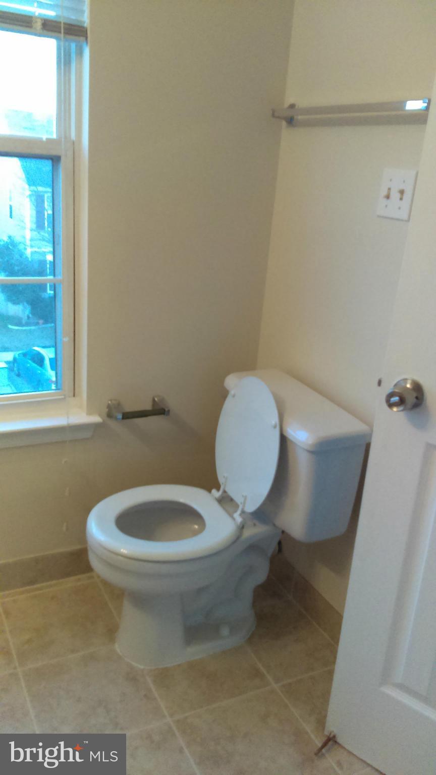 11117 Light Guard Loop Manassas, VA 20109 - Photo 13 of 25 a white toilet sitting next to a window