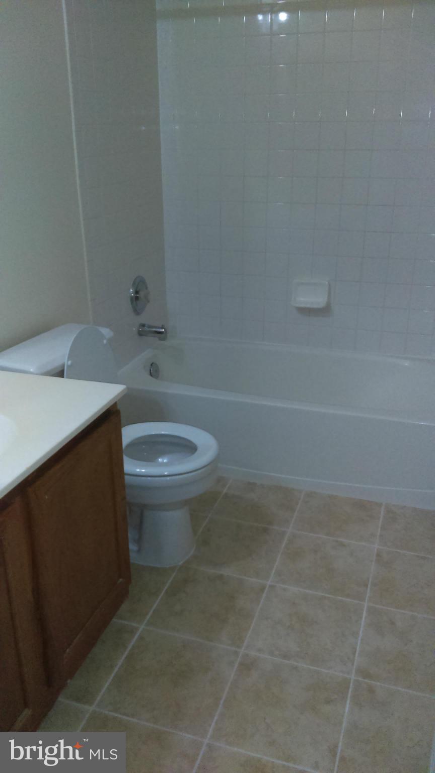 11117 Light Guard Loop Manassas, VA 20109 - Photo 17 of 25 a bathroom with a sink a toilet and a mirror