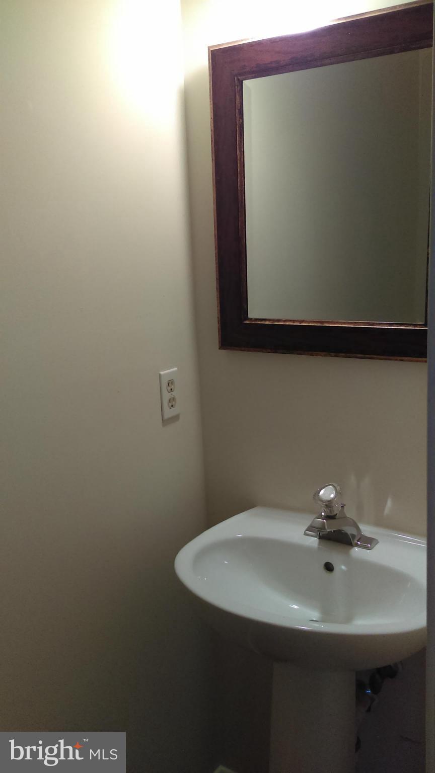 11117 Light Guard Loop Manassas, VA 20109 - Photo 20 of 25 a bathroom with a sink and a mirror