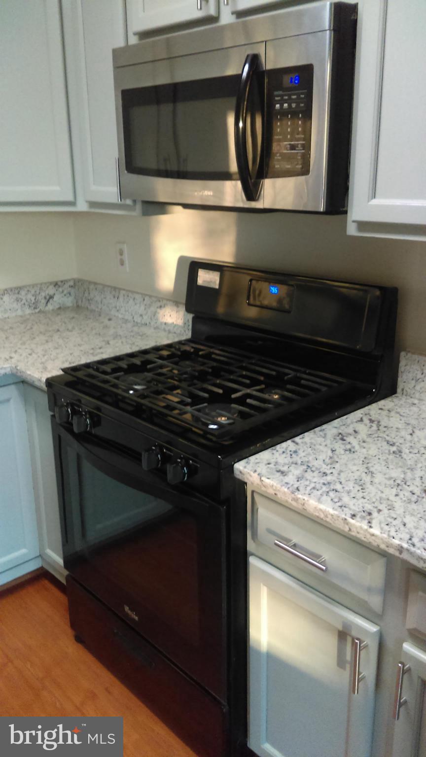 11117 Light Guard Loop Manassas, VA 20109 - Photo 7 of 25 a kitchen with a stove and a microwave