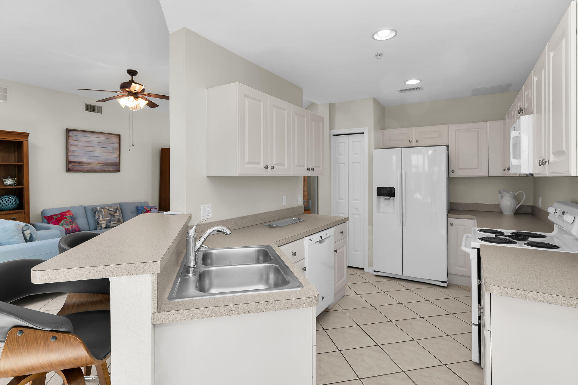 4685 Hawks Nest Way, Unit 101 Naples, FL 34114 - Photo 11 of 43 a kitchen that has a sink cabinets counter space and appliances