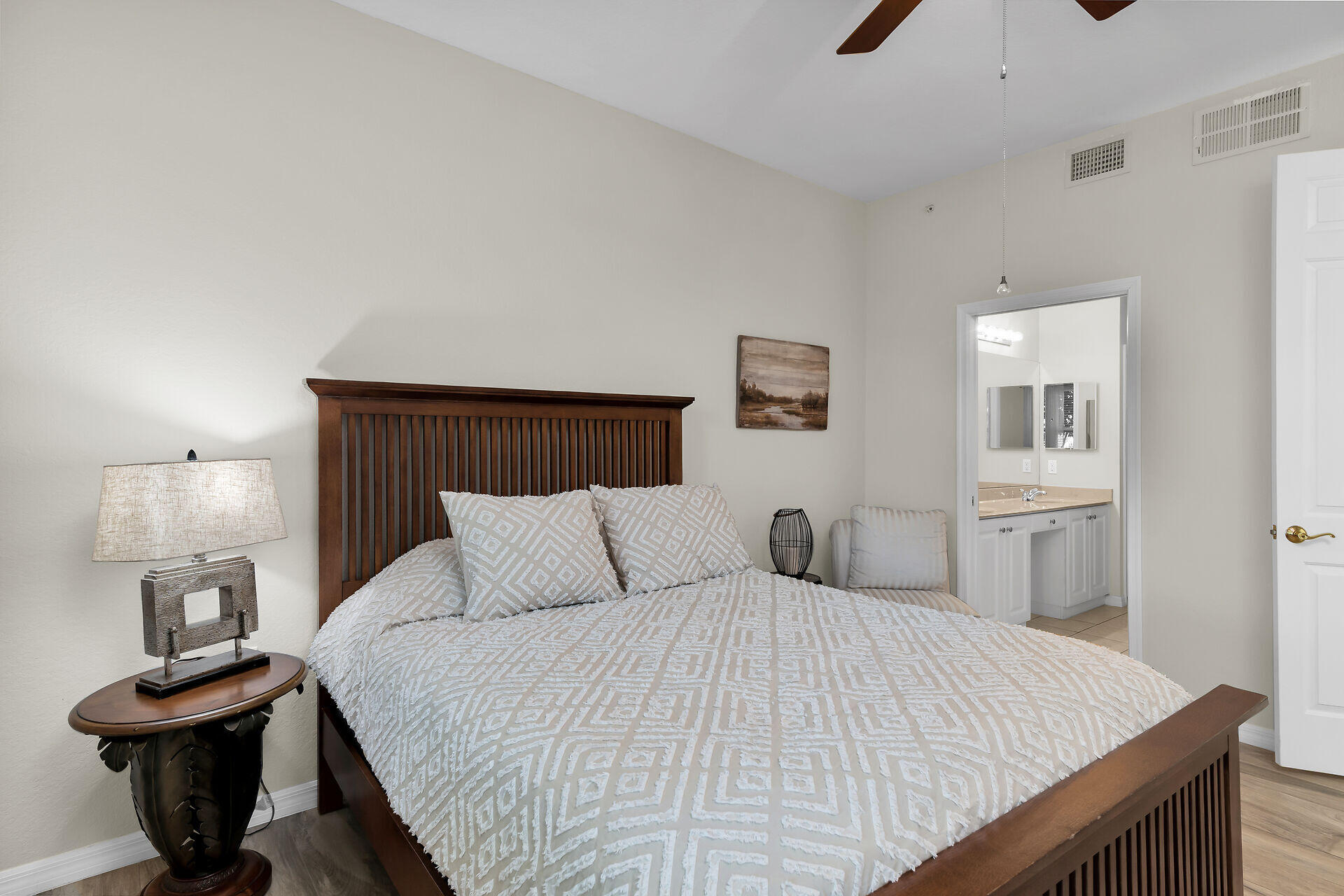 4685 Hawks Nest Way, Unit 101 Naples, FL 34114 - Photo 14 of 43 a bedroom with a bed and wooden floor