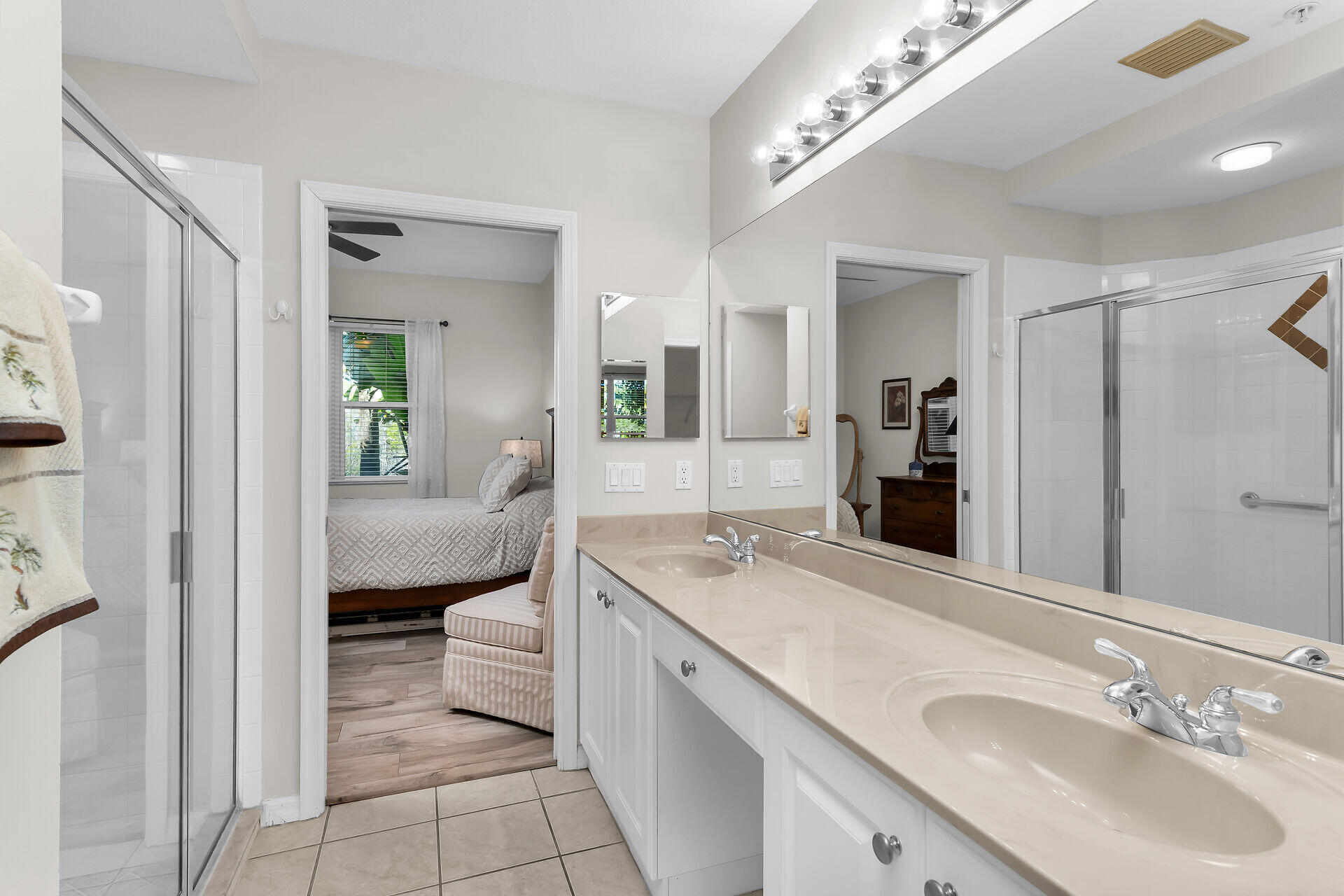 4685 Hawks Nest Way, Unit 101 Naples, FL 34114 - Photo 14 of 42 a spacious bathroom with a granite countertop sink and a mirror