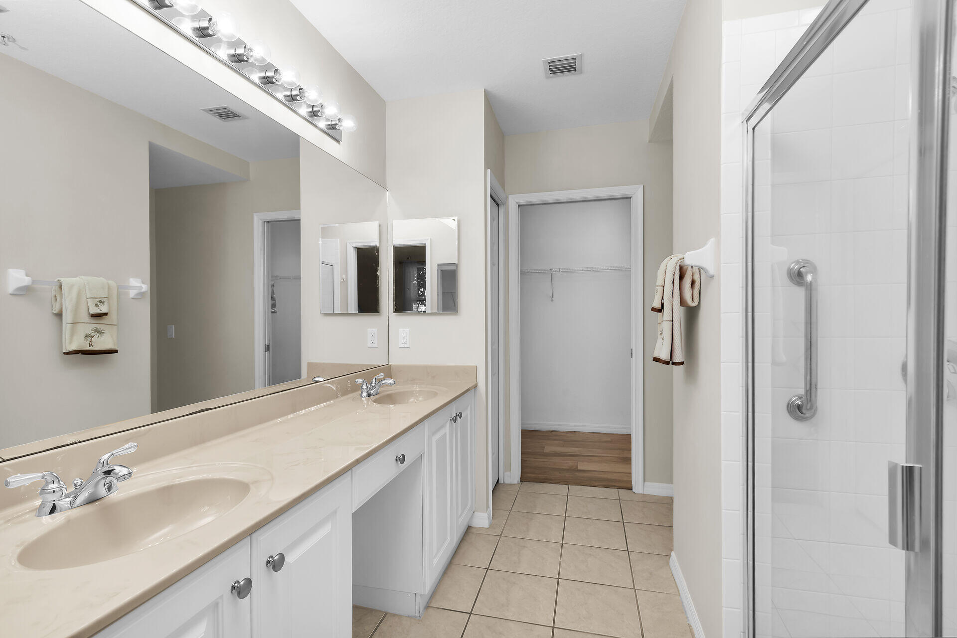 4685 Hawks Nest Way, Unit 101 Naples, FL 34114 - Photo 16 of 43 a spacious bathroom with a granite countertop sink mirror and shower