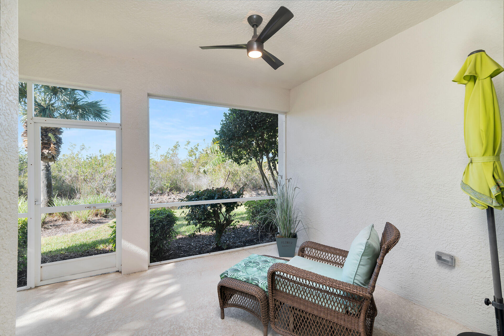4685 Hawks Nest Way, Unit 101 Naples, FL 34114 - Photo 21 of 43 a living room with furniture and a floor to ceiling window