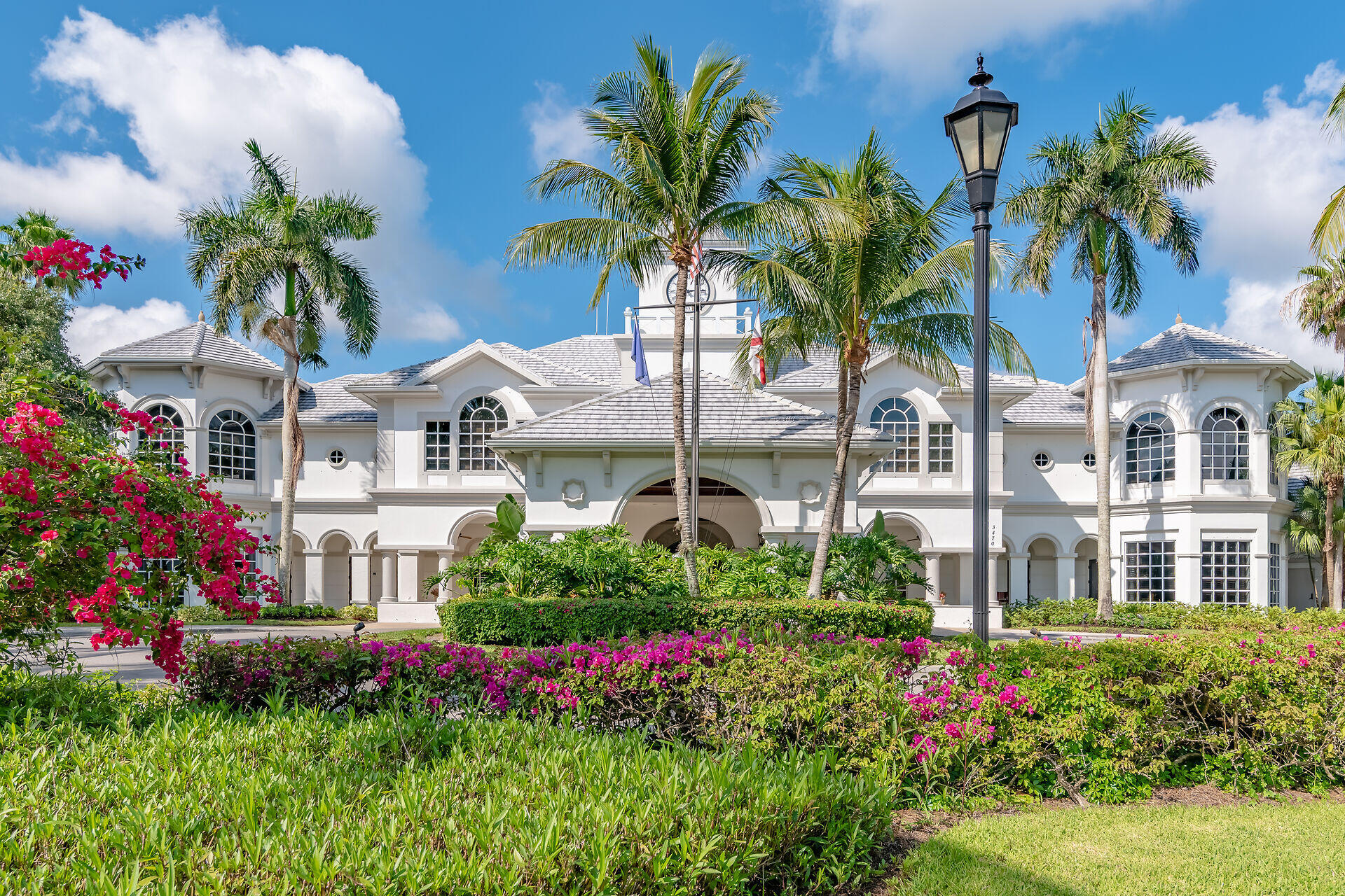 4685 Hawks Nest Way, Unit 101 Naples, FL 34114 - Photo 36 of 43 a view of a white house with a yard and potted plants
