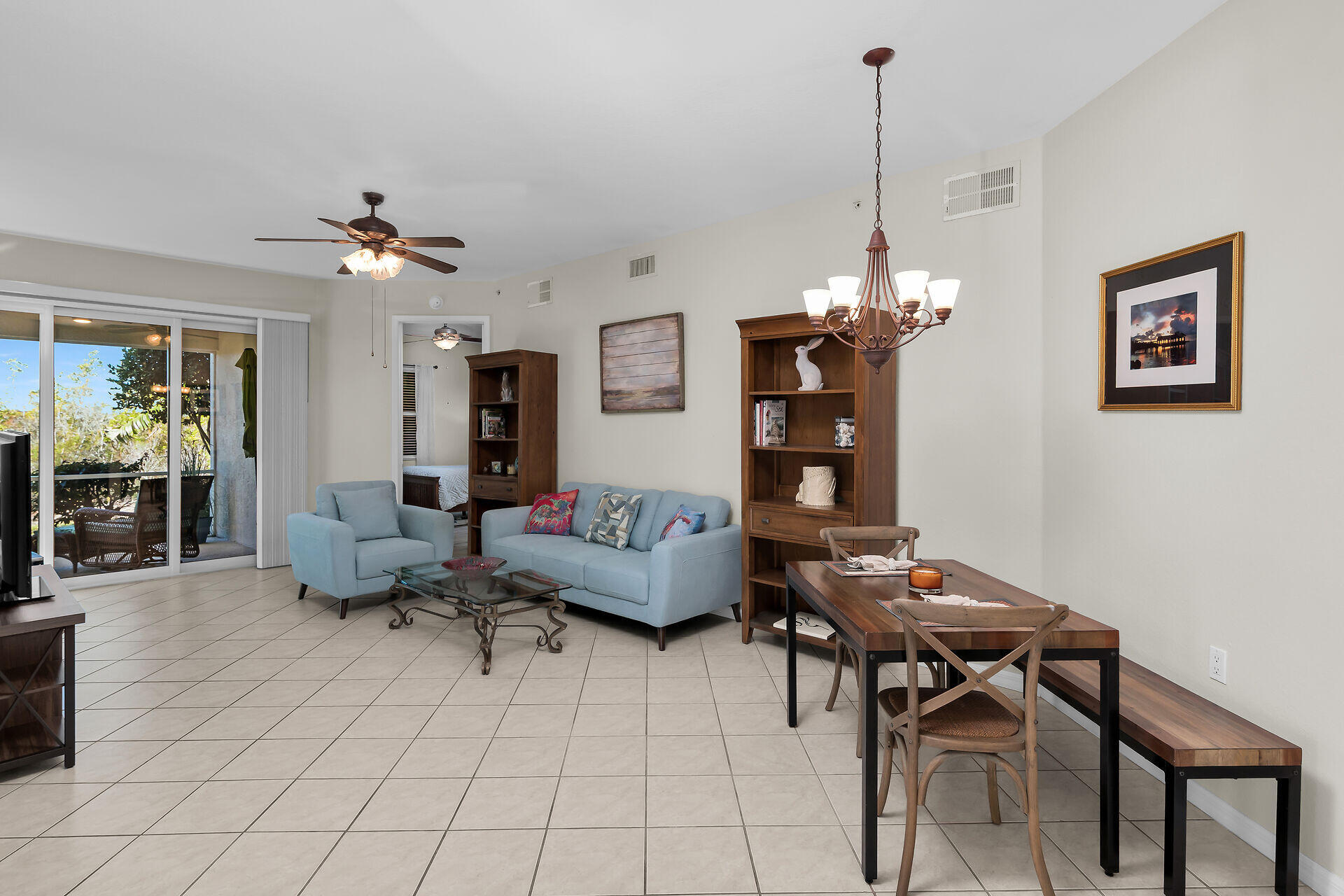 4685 Hawks Nest Way, Unit 101 Naples, FL 34114 - Photo 4 of 43 a living room with furniture a dining table and a chandelier