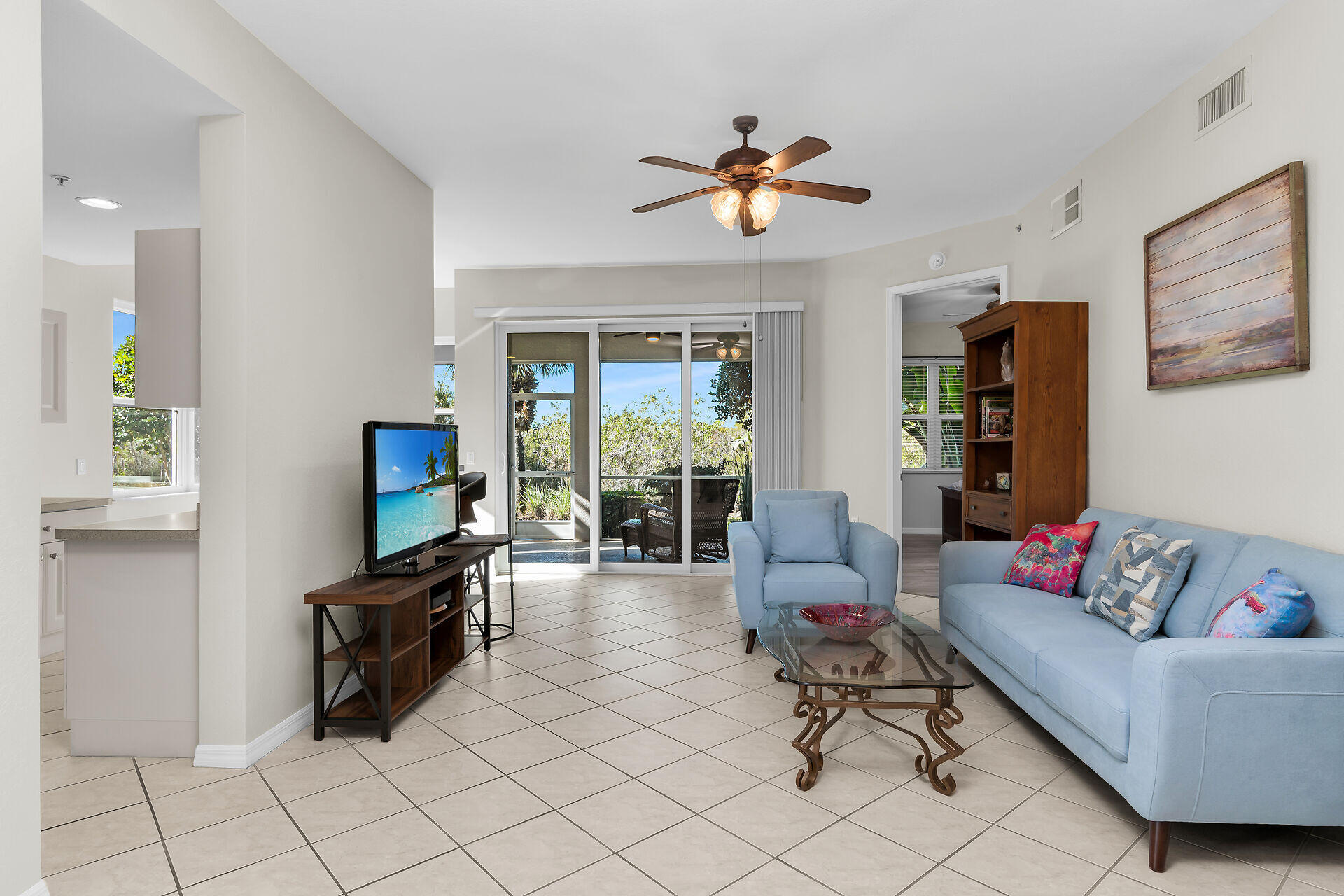 4685 Hawks Nest Way, Unit 101 Naples, FL 34114 - Photo 5 of 43 a living room with furniture and a flat screen tv