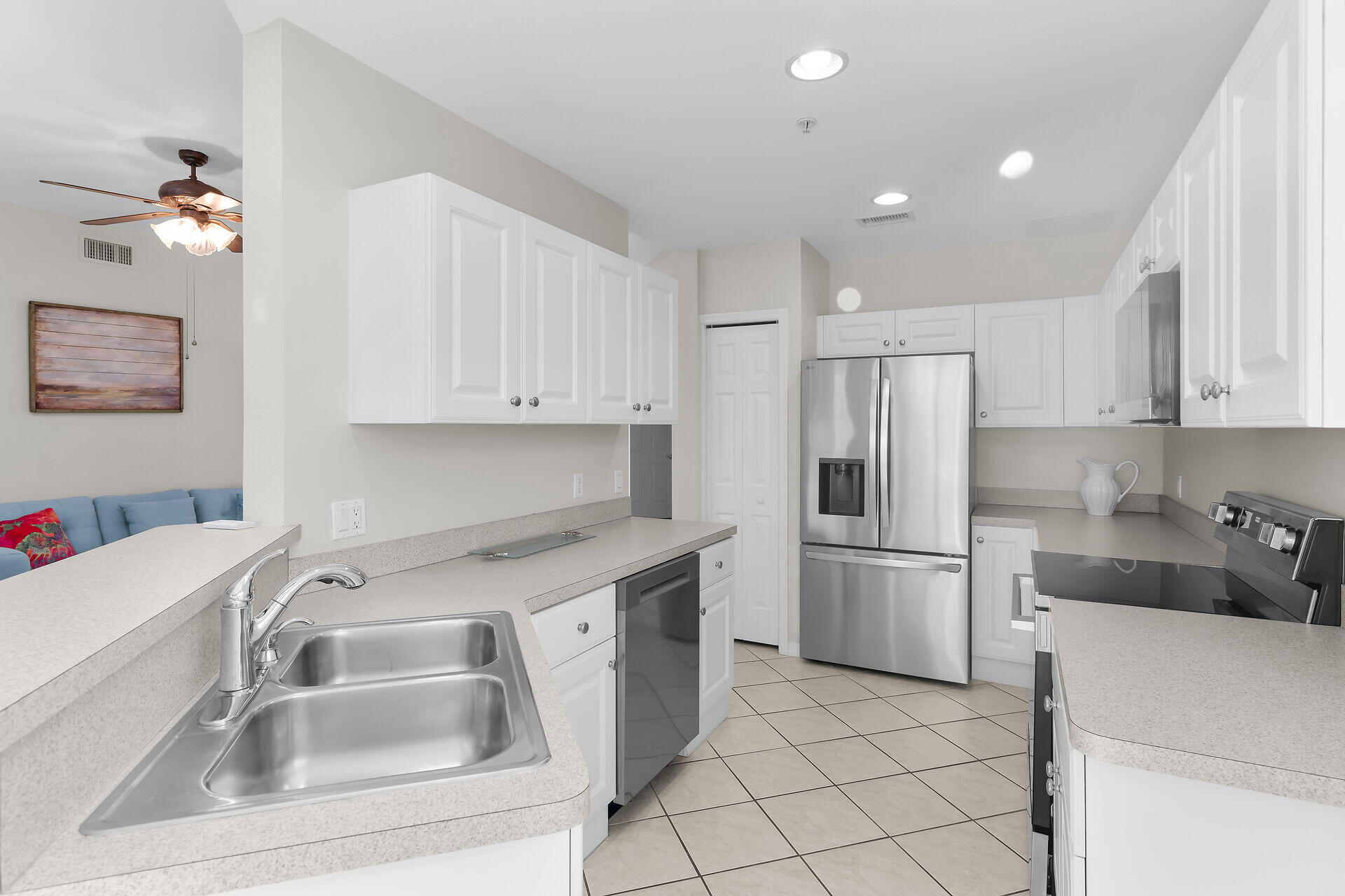 4685 Hawks Nest Way, Unit 101 Naples, FL 34114 - Photo 7 of 42 a kitchen that has a sink cabinets counter space and appliances