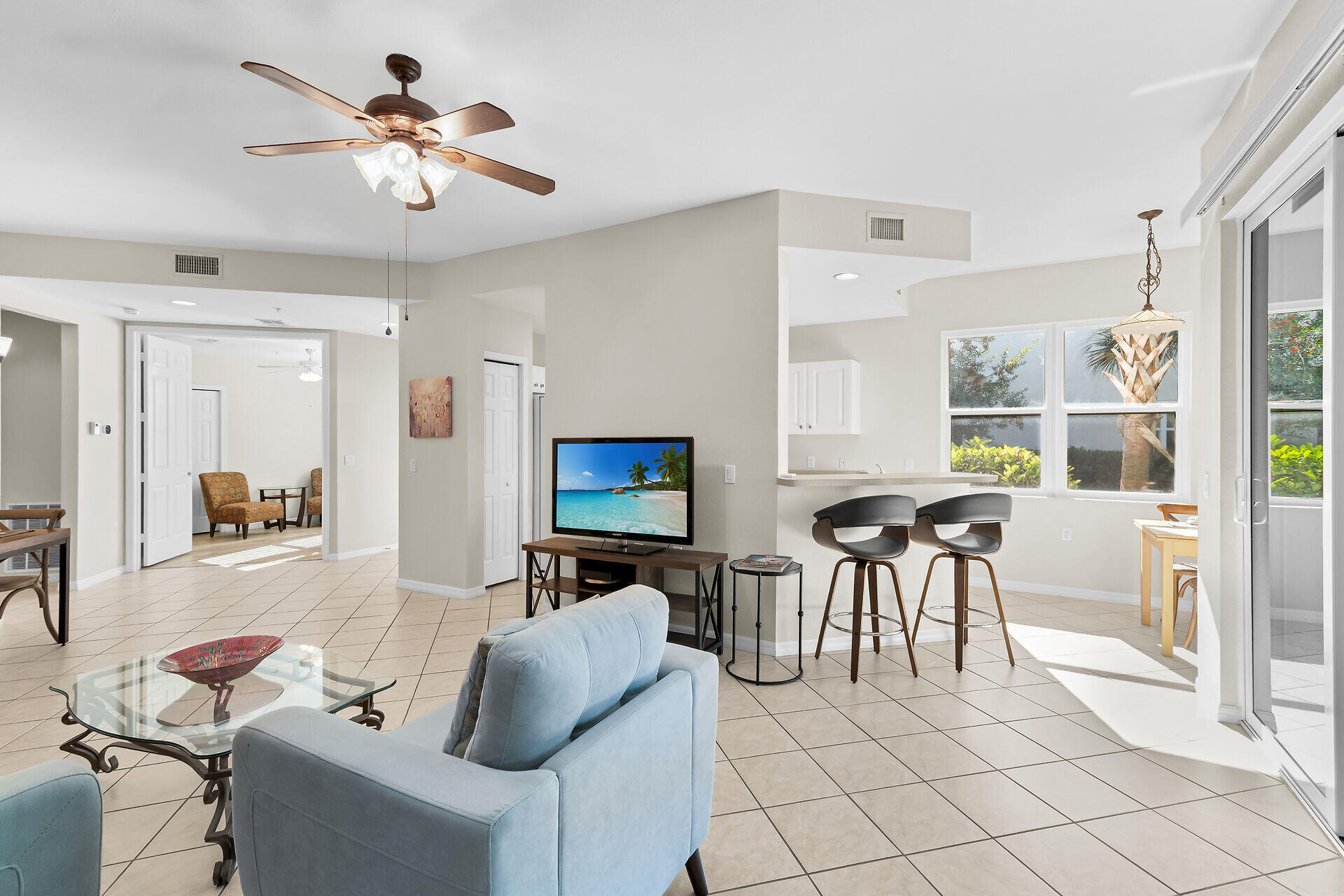 4685 Hawks Nest Way, Unit 101 Naples, FL 34114 - Photo 7 of 43 a living room with furniture a dining table and a piano table