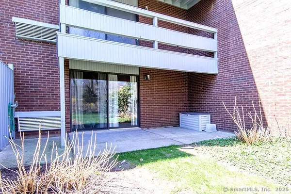 a brick building with a bench in front of house