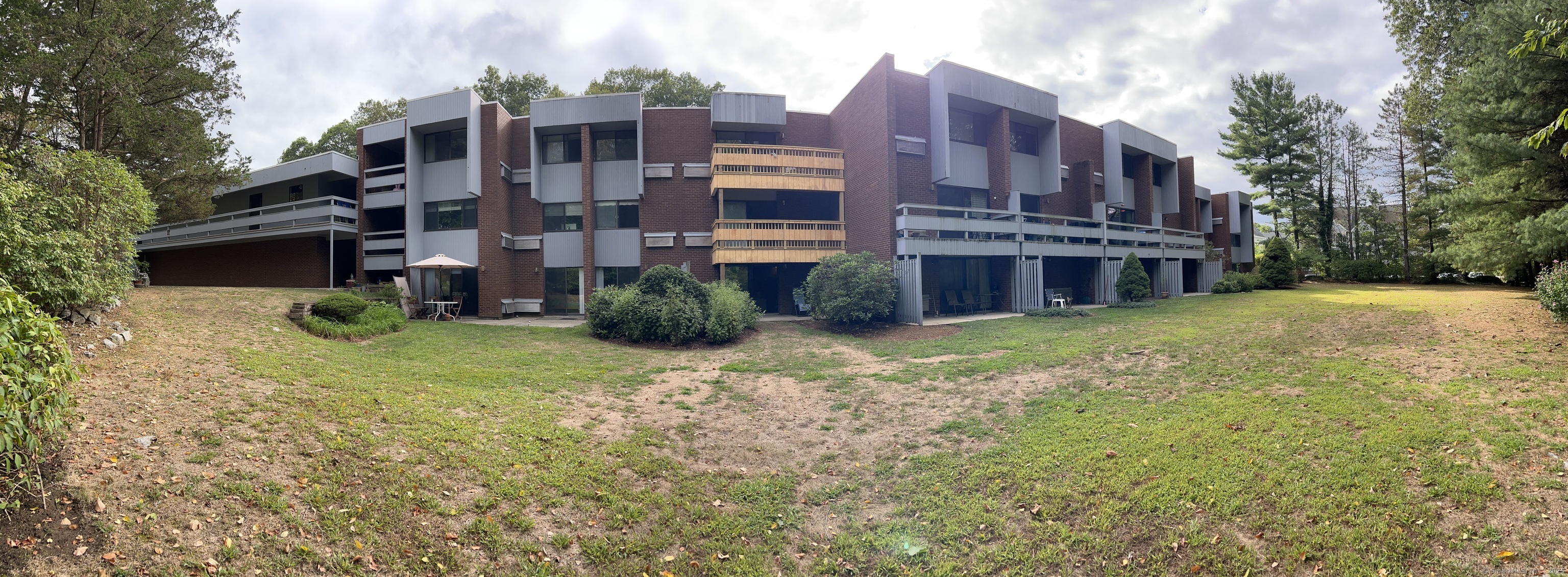 84 Wilton Crest Road, Unit 84 Wilton, CT 06897 - Photo 14 of 16 a view of a house with a yard and plants