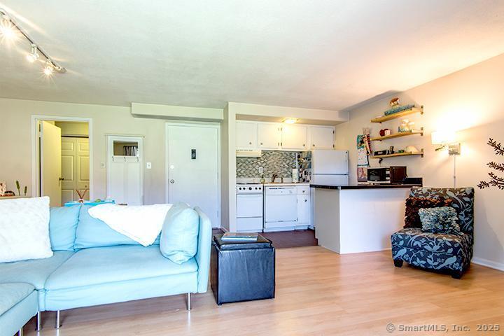 84 Wilton Crest Road, Unit 84 Wilton, CT 06897 - Photo 3 of 16 a living room with furniture and kitchen view