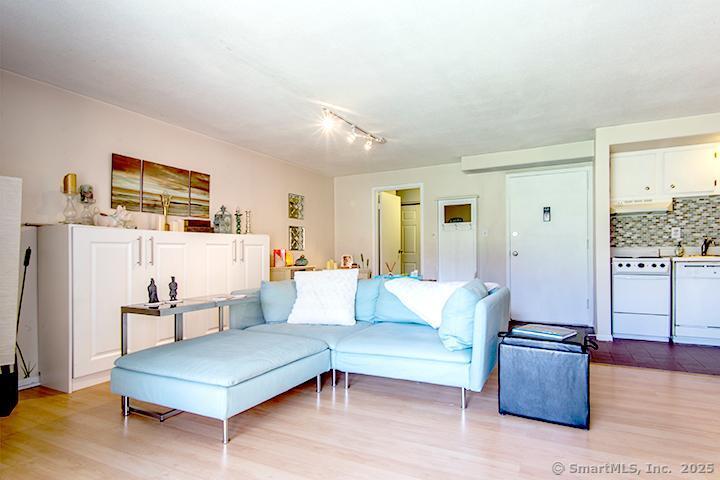 84 Wilton Crest Road, Unit 84 Wilton, CT 06897 - Photo 6 of 16 a living room with furniture and wooden floor