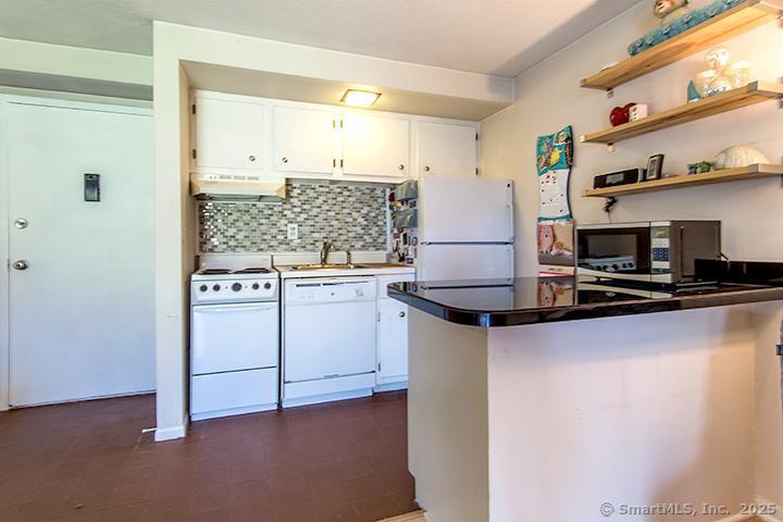 84 Wilton Crest Road, Unit 84 Wilton, CT 06897 - Photo 7 of 16 a kitchen with a sink cabinets and window