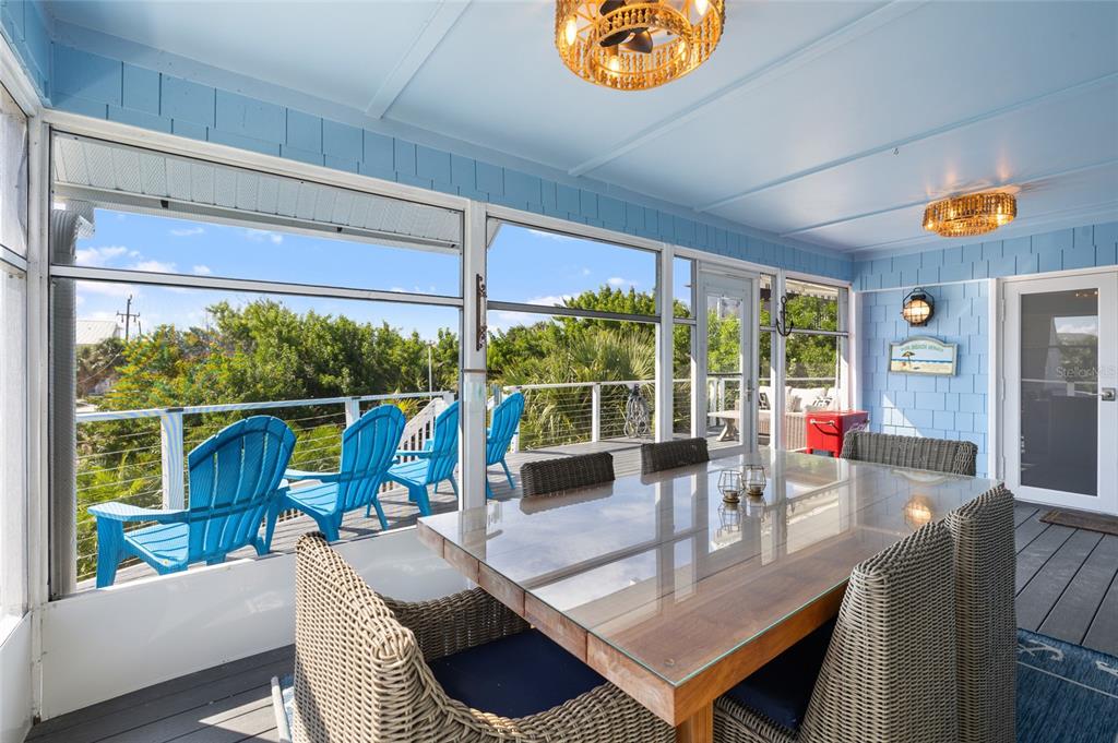9368 Little Gasparilla Boca Grande, FL 33921 - Photo 8 of 51 a view of a dining room with furniture large windows and wooden floor