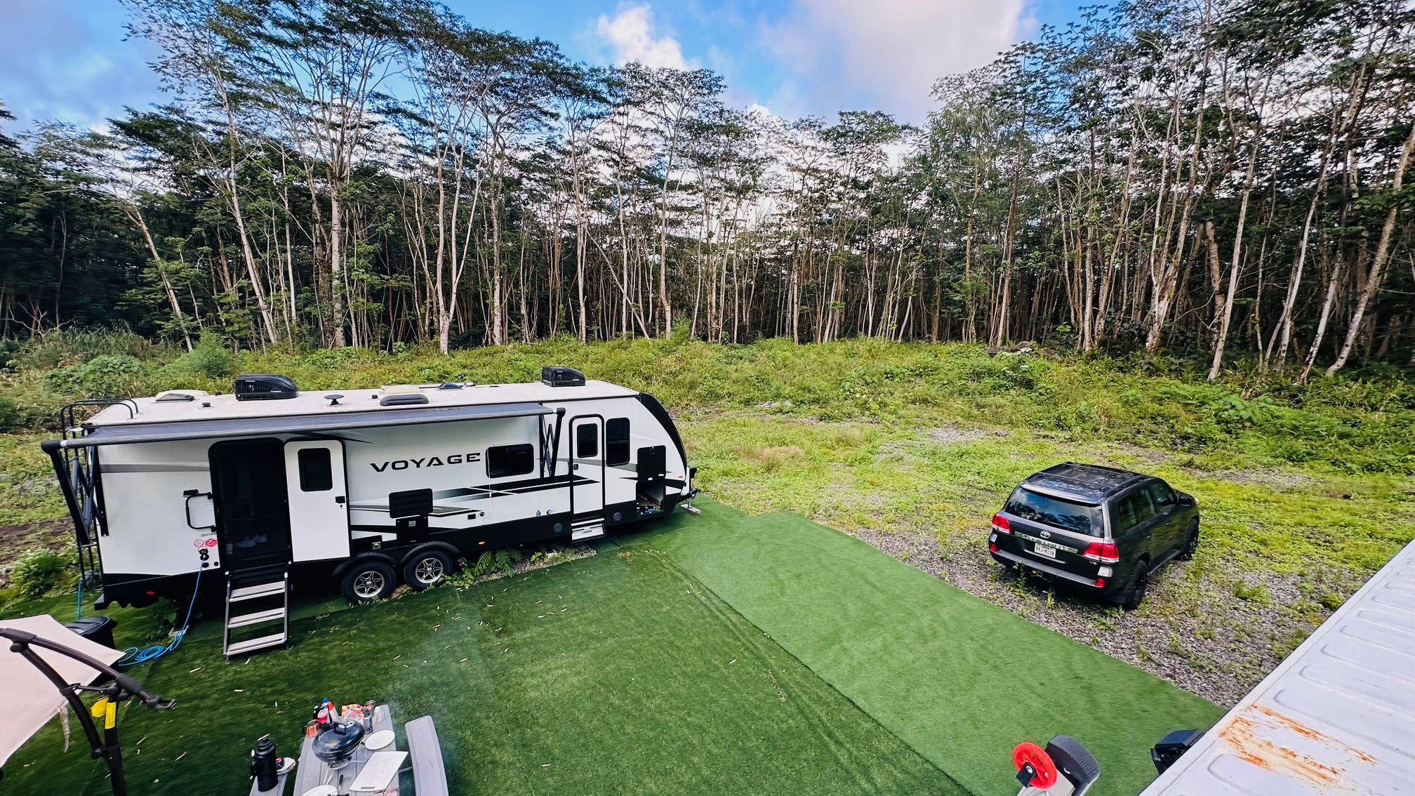 9 Kapoho Road Pahoa, HI 96778 - Photo 13 of 17 a car parked in front of a house with a yard
