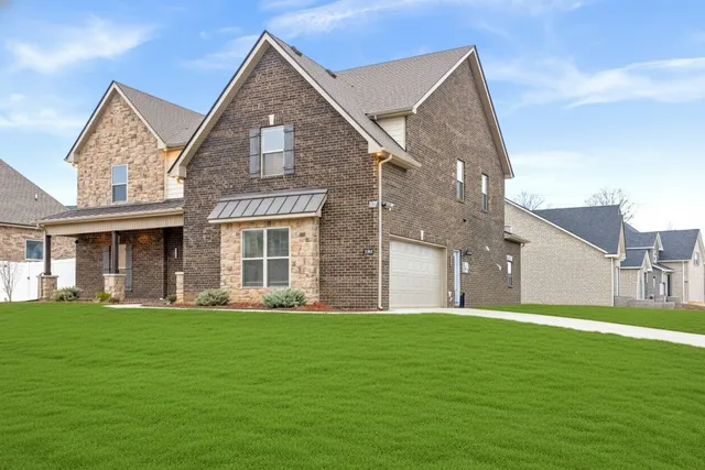 a front view of a house with a yard and garage