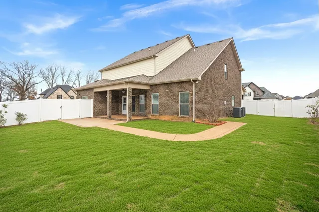 a view of a house with a backyard