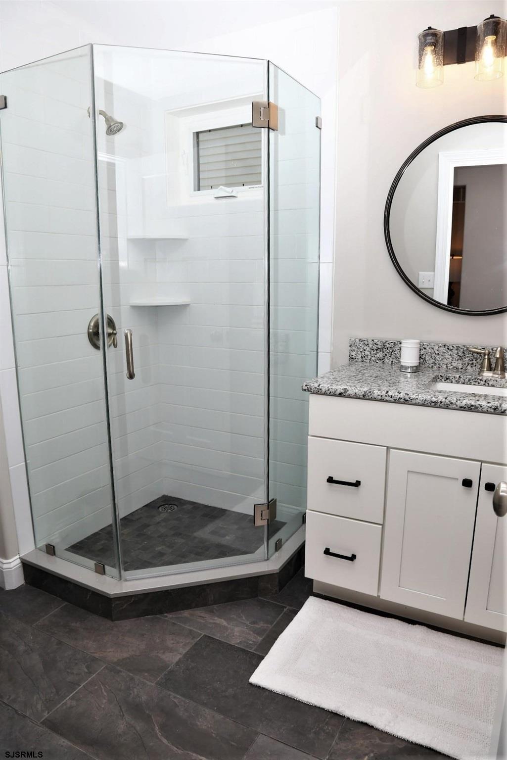 336 32nd Street South Brigantine, NJ 08203 - Photo 14 of 25 a bathroom with a granite countertop sink a mirror and a shower