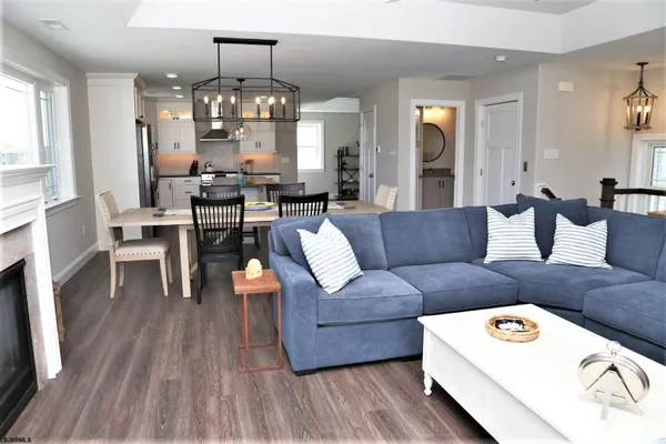 a living room with furniture and a chandelier