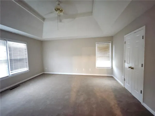 an empty room with a empty space and windows
