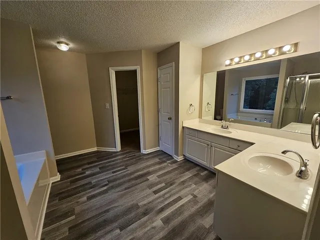 a bathroom with double vanity sink and mirror