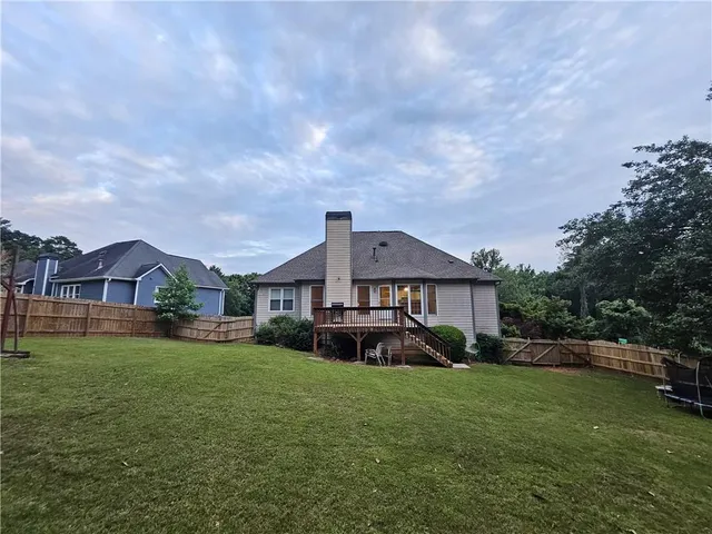 a house view with a play ground in the back