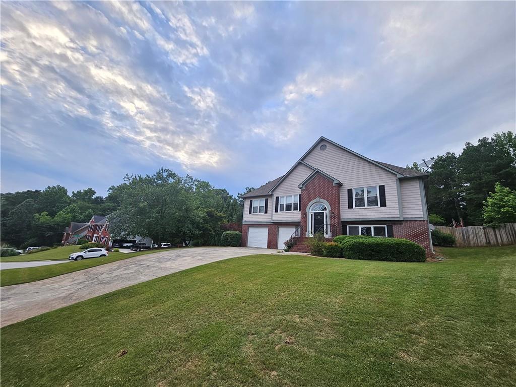144 Hunters Trace Dallas, GA 30157 - Photo 3 of 34 a front view of a house with a yard and trees