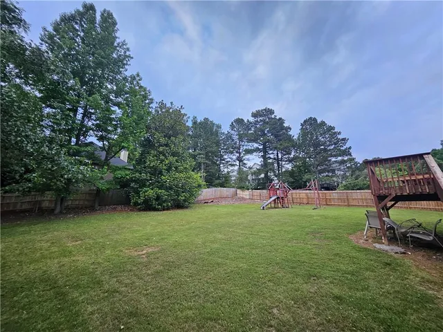 a view of a backyard with sitting area
