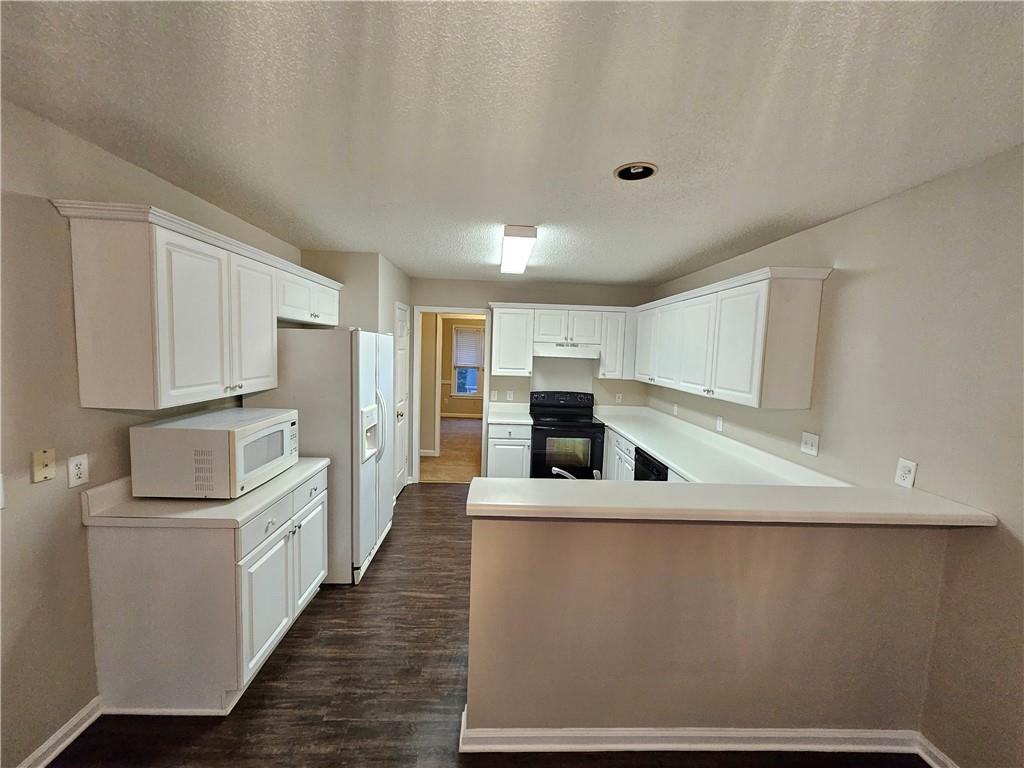 144 Hunters Trace Dallas, GA 30157 - Photo 7 of 34 a kitchen with stainless steel appliances a refrigerator and a stove