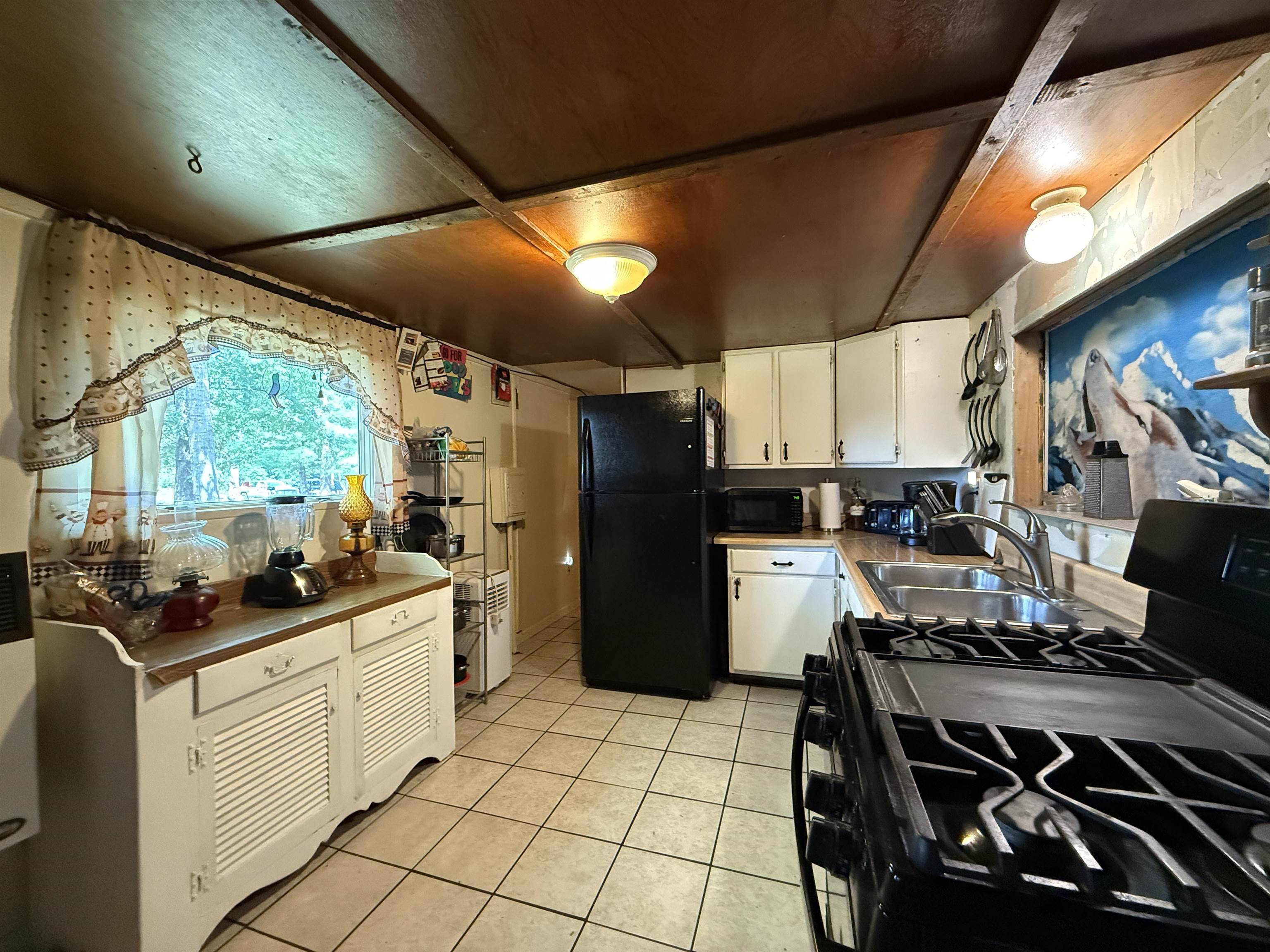 104 Head Of River Road Corbin City, NJ 08270 - Photo 15 of 50 a kitchen with a sink appliances cabinets and a large window