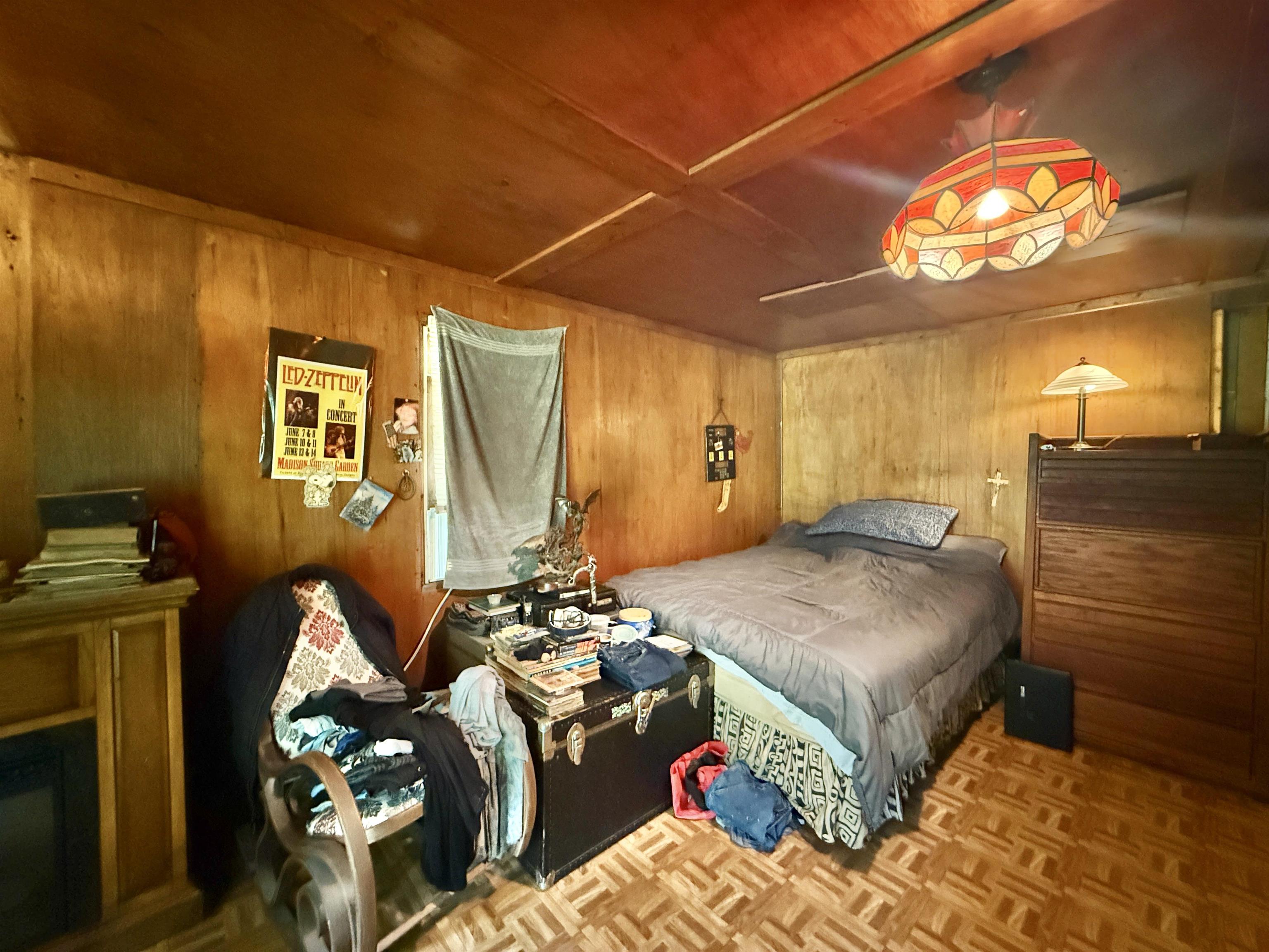 104 Head Of River Road Corbin City, NJ 08270 - Photo 21 of 50 a bedroom with a bed and chandelier