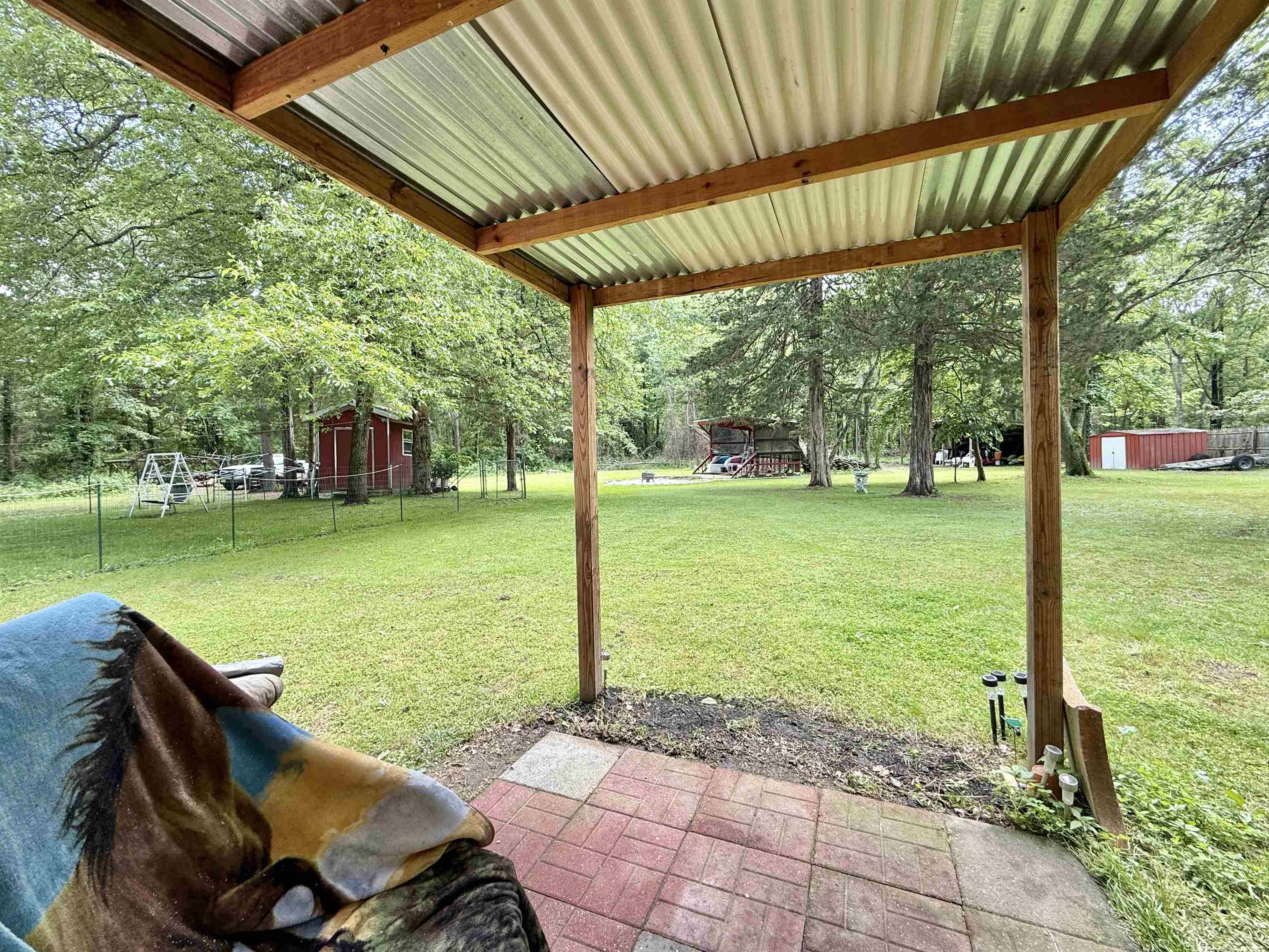 104 Head Of River Road Corbin City, NJ 08270 - Photo 46 of 50 a view of a backyard with table and chairs under an umbrella