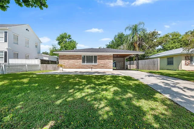 a view of a house with a backyard and a patio