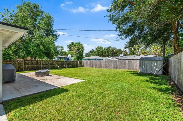 a view of a backyard with wooden fence