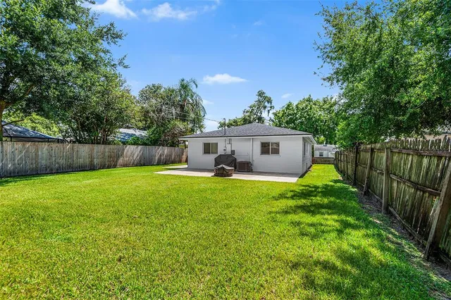 a front view of house with a garden