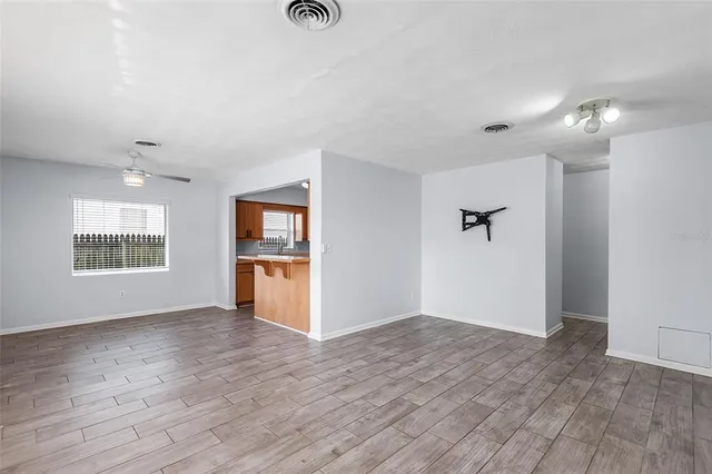 wooden floor in an empty room with a window