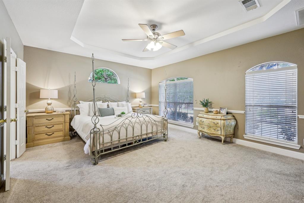 5603 Blazing Star Road Frisco, TX 75036 - Photo 17 of 39 a bedroom with a bed and a chandelier