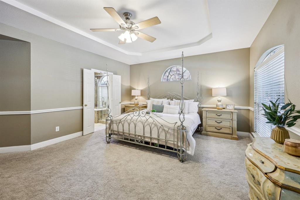 5603 Blazing Star Road Frisco, TX 75036 - Photo 18 of 39 a spacious bedroom with a bed and a chandelier