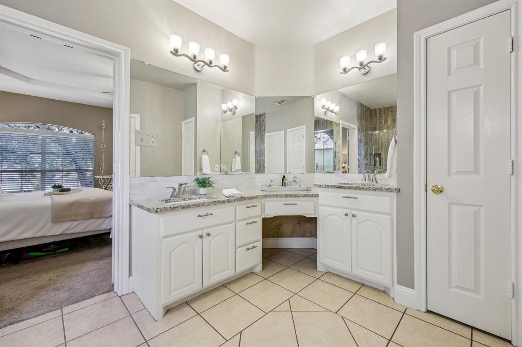 5603 Blazing Star Road Frisco, TX 75036 - Photo 19 of 39 a spacious bathroom with a granite countertop sink a mirror and a