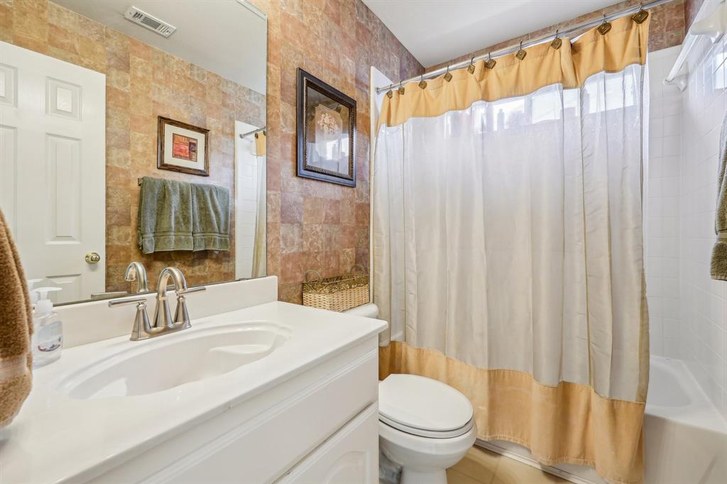 5603 Blazing Star Road Frisco, TX 75036 - Photo 29 of 39 a bathroom with a sink a toilet and shower curtain