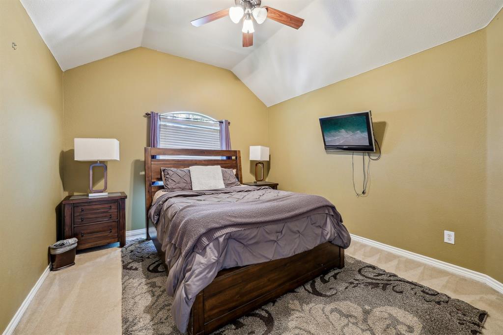 5603 Blazing Star Road Frisco, TX 75036 - Photo 30 of 39 a bedroom with a bed and a chandelier