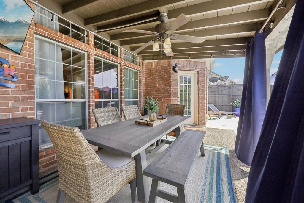 5603 Blazing Star Road Frisco, TX 75036 - Photo 33 of 39 a view of a deck with table and chairs and wooden floor